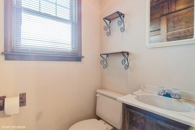 bathroom with vanity, toilet, and plenty of natural light