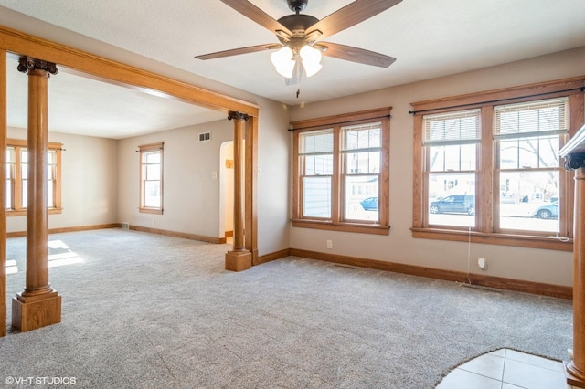 carpeted spare room featuring ceiling fan