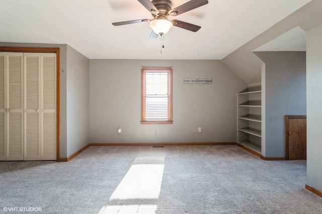 interior space with light carpet, vaulted ceiling, and ceiling fan