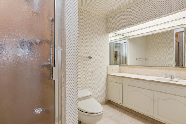 bathroom with toilet, an enclosed shower, ornamental molding, and vanity