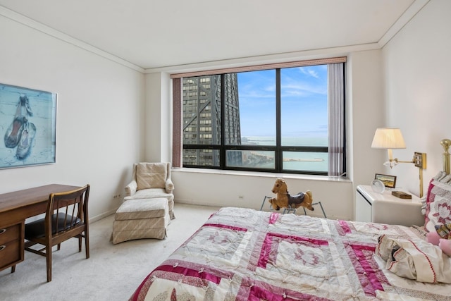 bedroom featuring crown molding, a water view, and light colored carpet