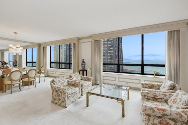 carpeted living room featuring crown molding, a water view, and a notable chandelier