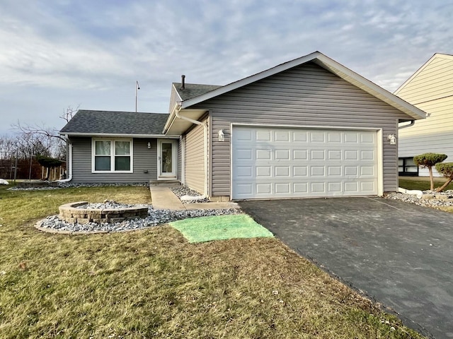 ranch-style home featuring a front lawn and a garage