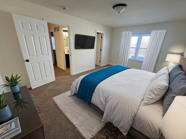 carpeted bedroom featuring ensuite bath