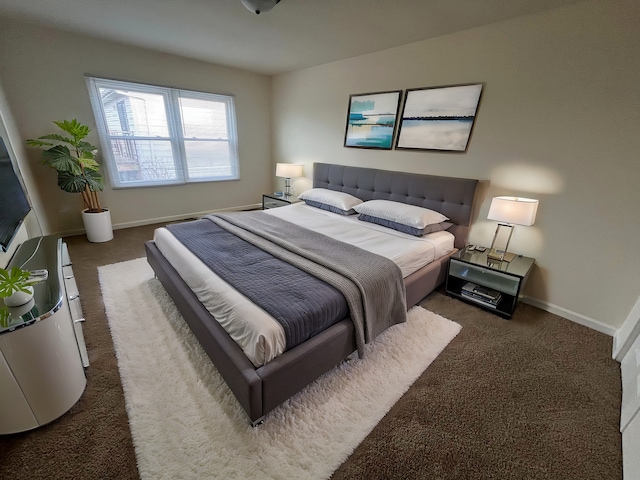 bedroom featuring dark carpet