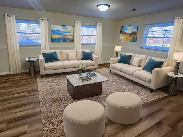 living room featuring plenty of natural light and dark wood-type flooring