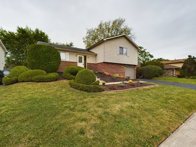 tri-level home with a garage and a front lawn