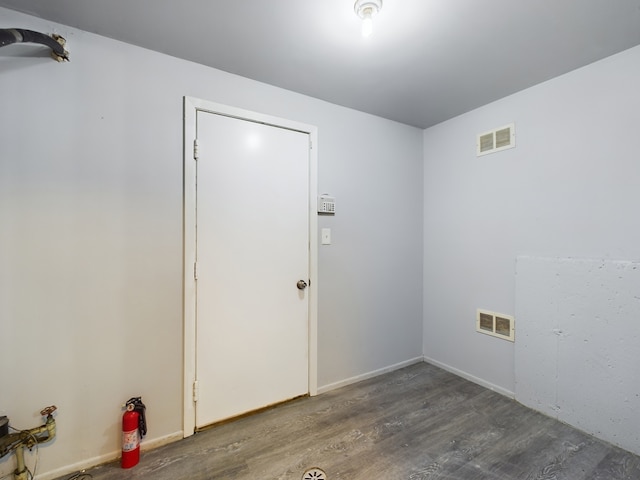 laundry room featuring dark wood-type flooring