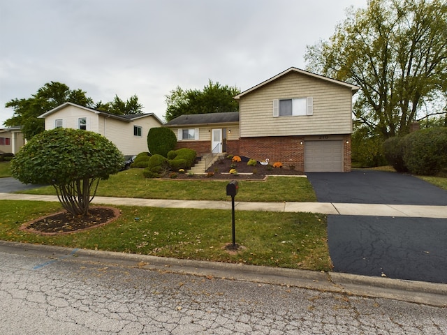 tri-level home with a front yard and a garage