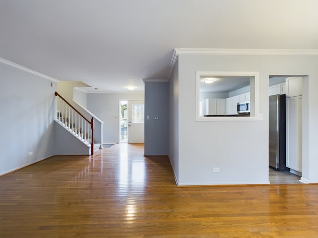 unfurnished room featuring hardwood / wood-style flooring and ornamental molding