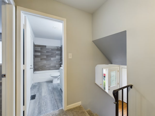 hallway with hardwood / wood-style floors