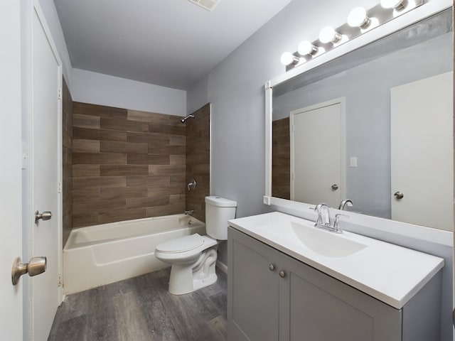 full bathroom with toilet, hardwood / wood-style floors, vanity, and tiled shower / bath