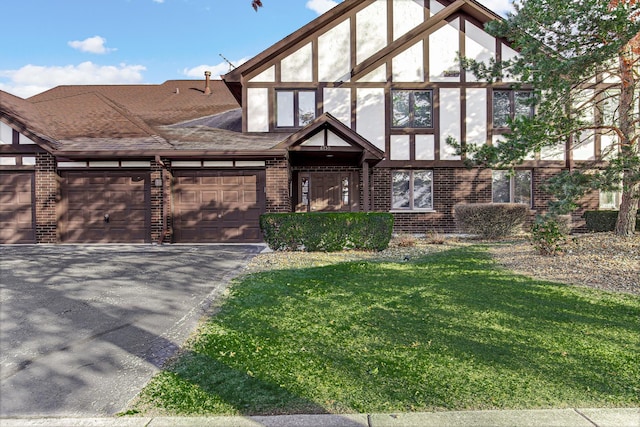 english style home featuring a front lawn