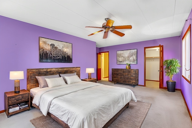 bedroom with carpet, a spacious closet, a closet, and ceiling fan