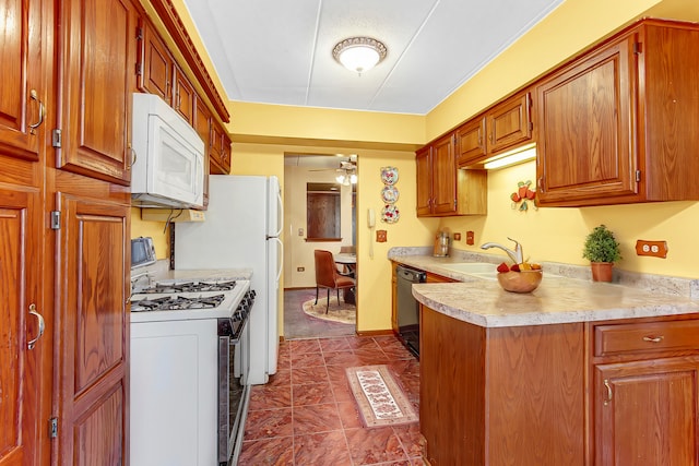 kitchen featuring ceiling fan, sink, and white appliances