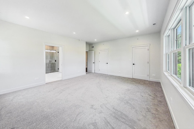 empty room with light carpet, recessed lighting, visible vents, and baseboards