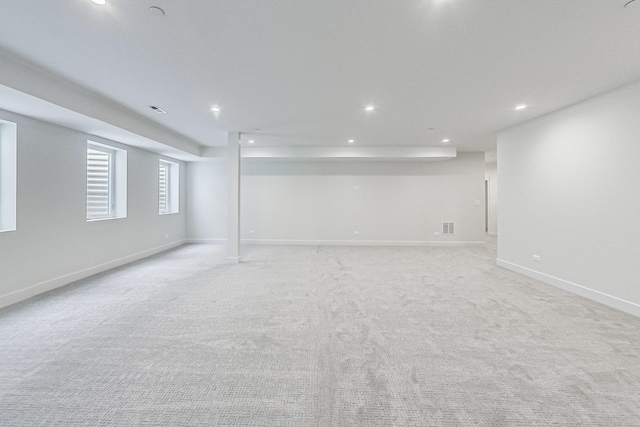 basement with recessed lighting, visible vents, baseboards, and light colored carpet