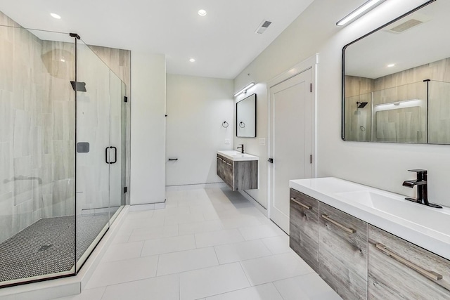 bathroom with recessed lighting, two vanities, visible vents, a sink, and a shower stall