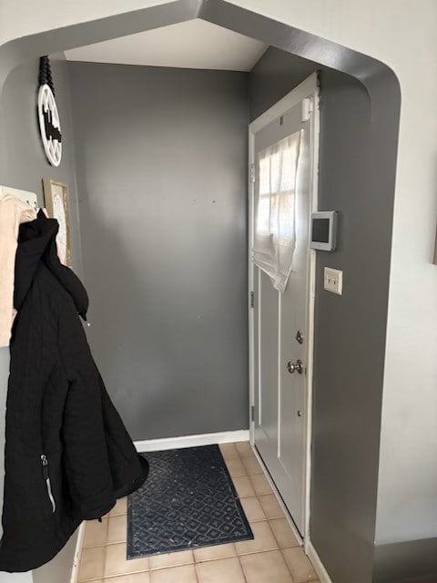 doorway to outside with light tile patterned floors