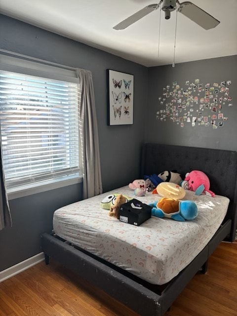 bedroom with ceiling fan and wood-type flooring