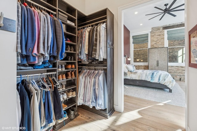 spacious closet with hardwood / wood-style flooring and ceiling fan