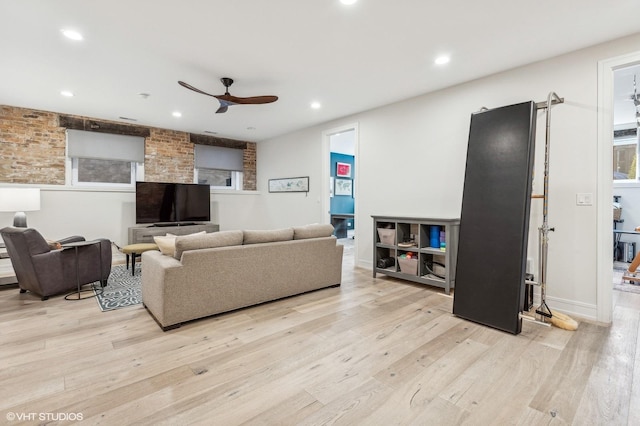 living room featuring ceiling fan and light hardwood / wood-style floors