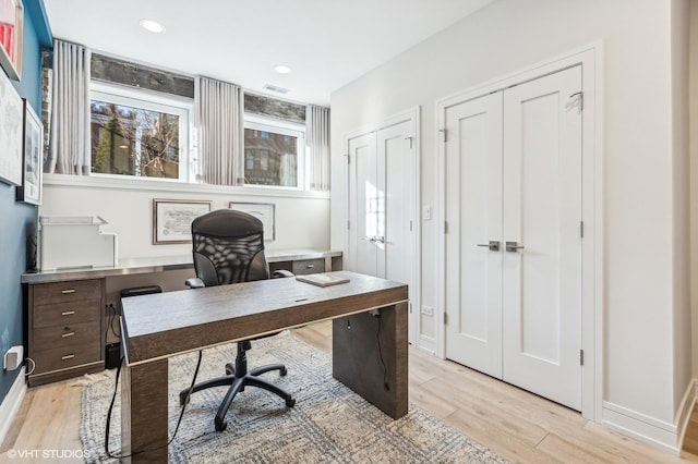 office space with light hardwood / wood-style flooring