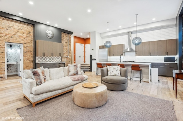 living room featuring light hardwood / wood-style floors and sink