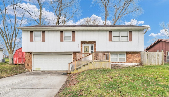 bi-level home with a garage and a front lawn