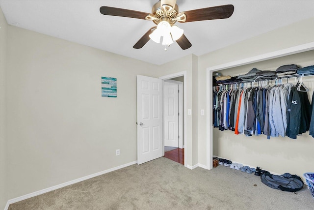 unfurnished bedroom with ceiling fan, a closet, and light colored carpet