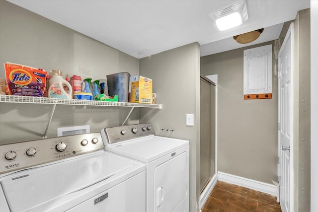 laundry area with dark tile patterned flooring, independent washer and dryer, and electric panel