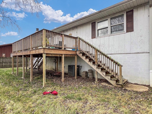 rear view of house featuring central AC and a wooden deck