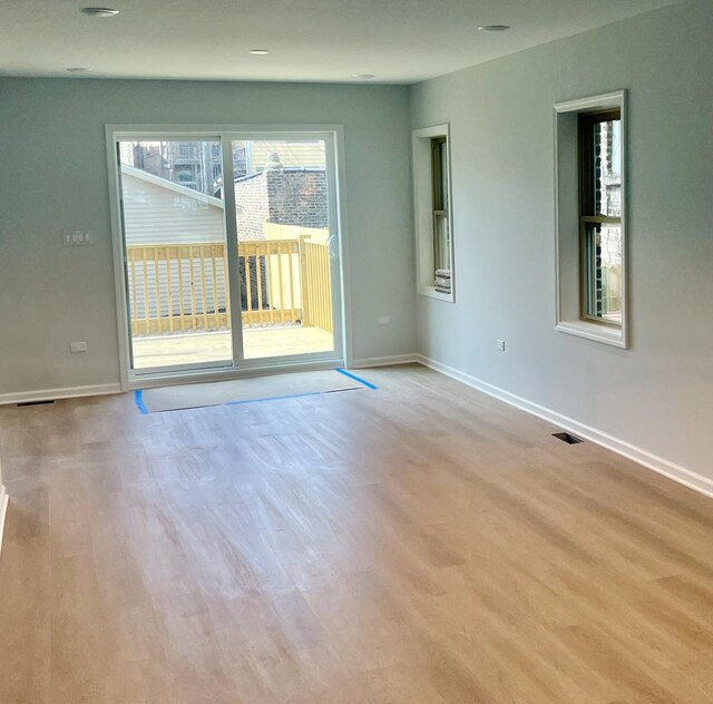 empty room with light hardwood / wood-style floors