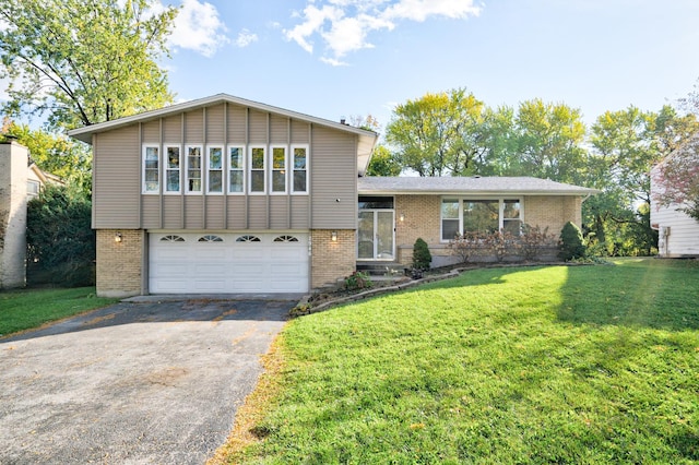 tri-level home featuring a garage and a front lawn