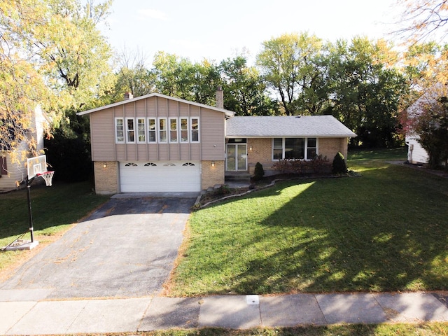 view of front of home with a front yard and a garage