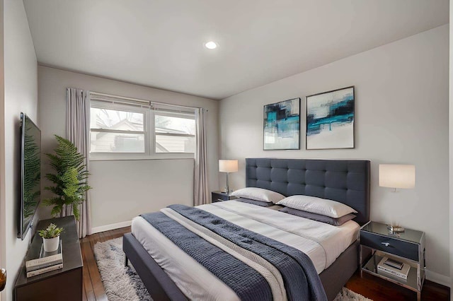 bedroom with dark wood-type flooring