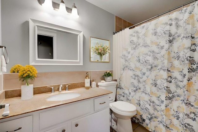 bathroom with tile patterned floors, vanity, toilet, and a shower with shower curtain