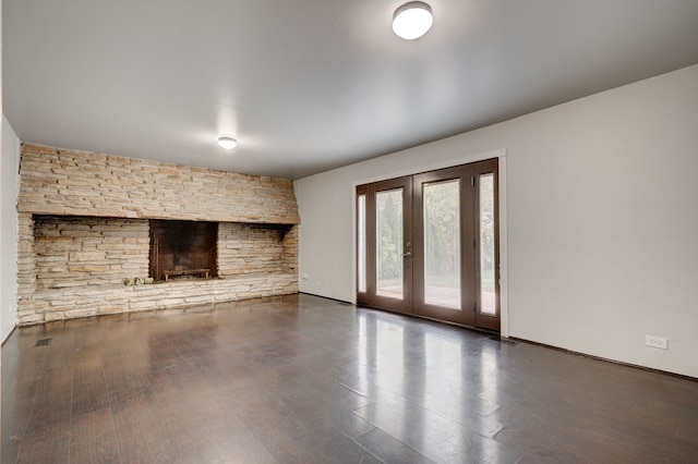 unfurnished living room with a fireplace and french doors