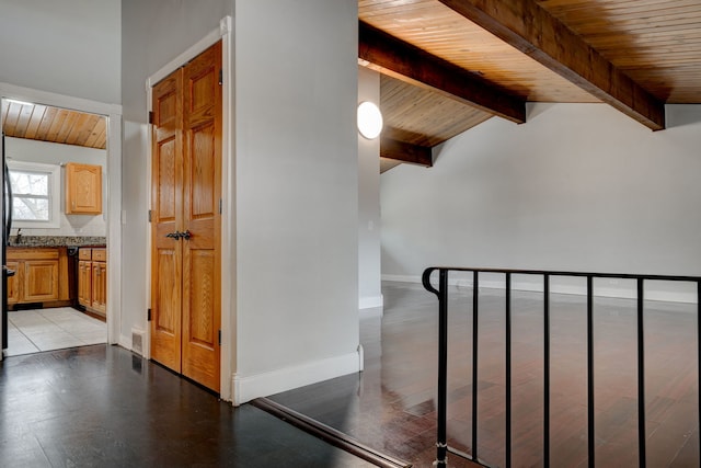 stairs with wood-type flooring, lofted ceiling with beams, and wood ceiling