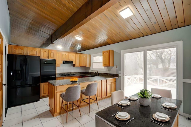 kitchen featuring backsplash, black appliances, wooden ceiling, a kitchen island, and a breakfast bar area