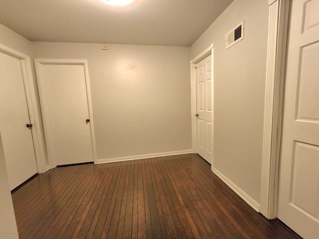 corridor featuring dark wood-type flooring