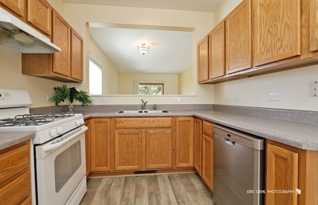 kitchen featuring dishwasher, sink, white gas range oven, and light hardwood / wood-style flooring