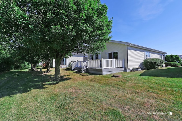 exterior space with a lawn and a wooden deck