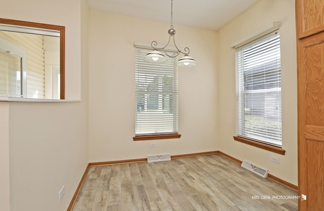 spare room with light hardwood / wood-style flooring