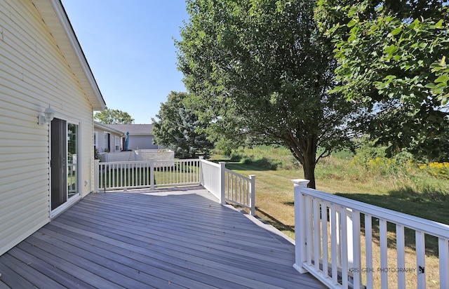 wooden deck with a lawn