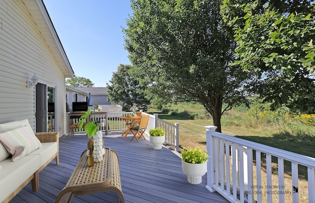 wooden terrace with a lawn