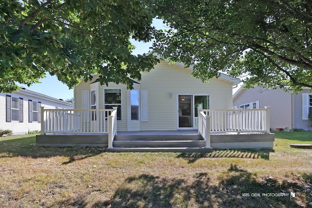 view of front of house with a wooden deck and a front yard