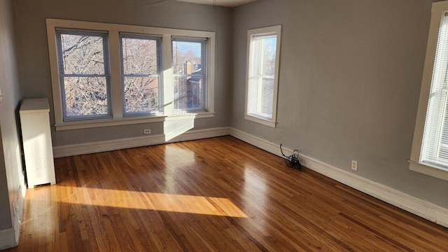 unfurnished room featuring hardwood / wood-style flooring