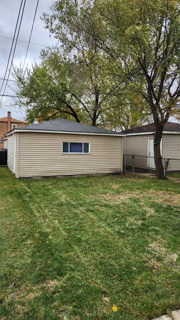 rear view of house featuring a lawn