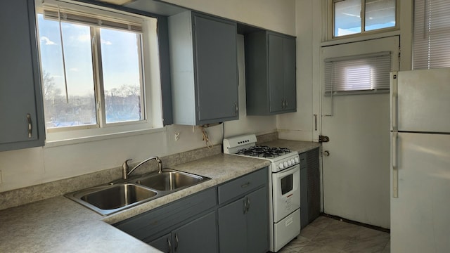 kitchen featuring sink, white appliances, a healthy amount of sunlight, and gray cabinetry